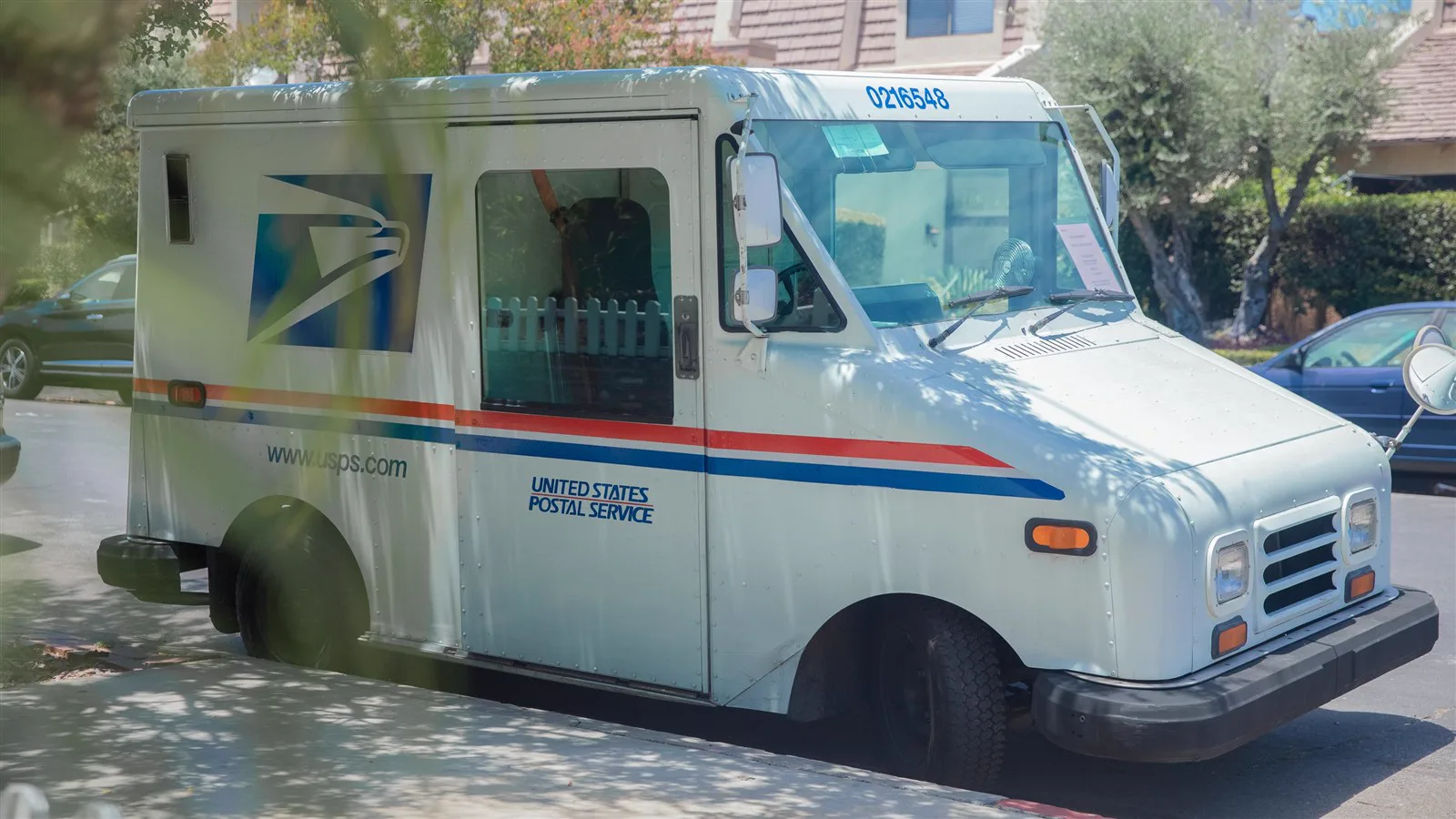 United States Postal Service delivery van parked on a residential street