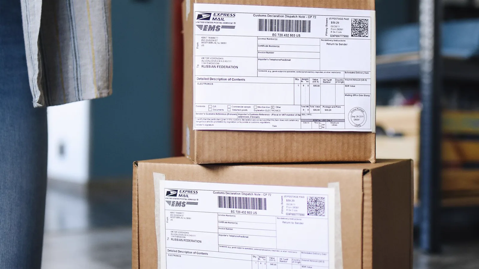 Stack of cardboard shipping boxes with mailing labels