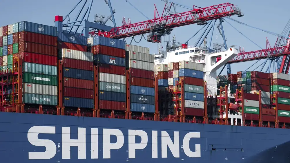 Container ship docked at a port with cranes