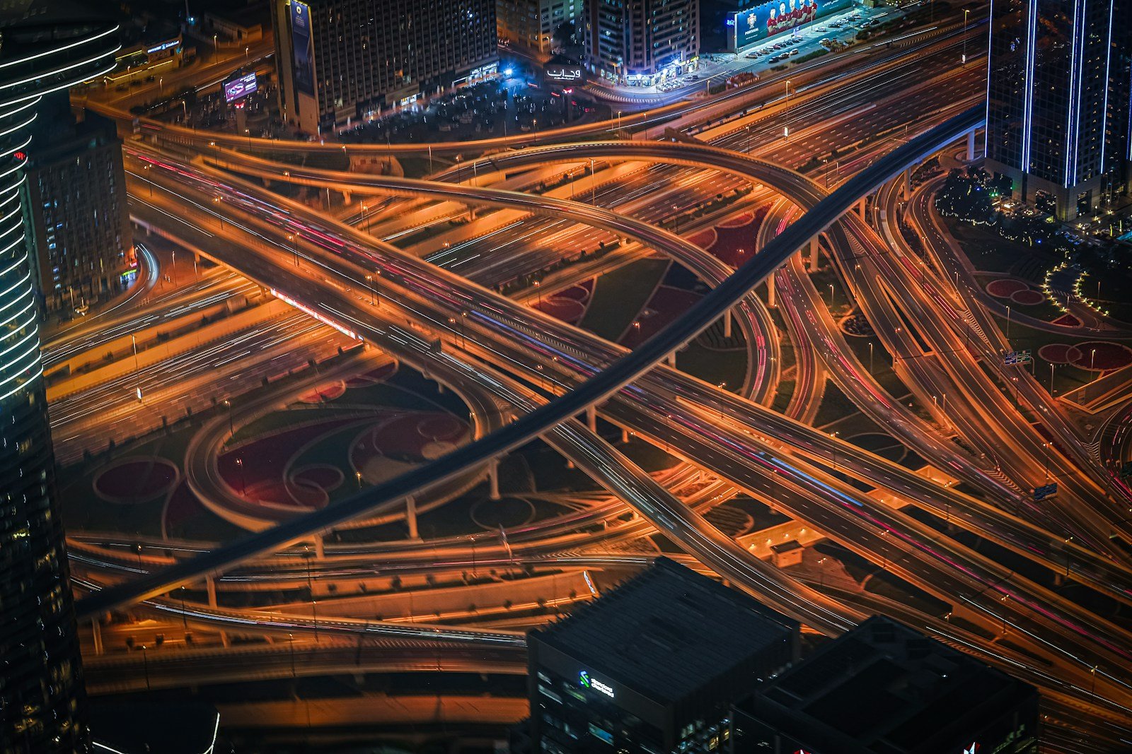 Aerial long-exposure view of a busy highway interchange at night — optimization in motion